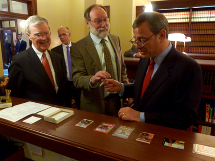 Chief Justice Roberts signing his Green Bag Magazine “Supreme Court Sluggers” Baseball Card 